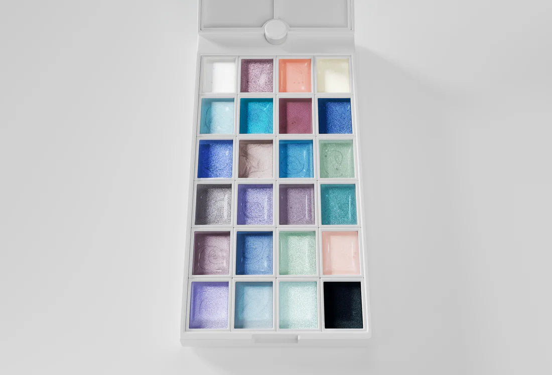 Set of colorful nail polish gels in a white box on a light gray background