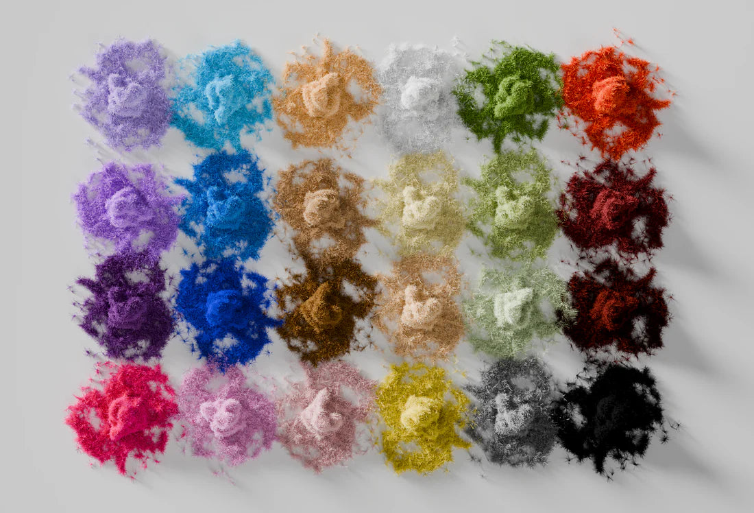 Assorted colorful piles of flocking powder arranged in a grid on a white background